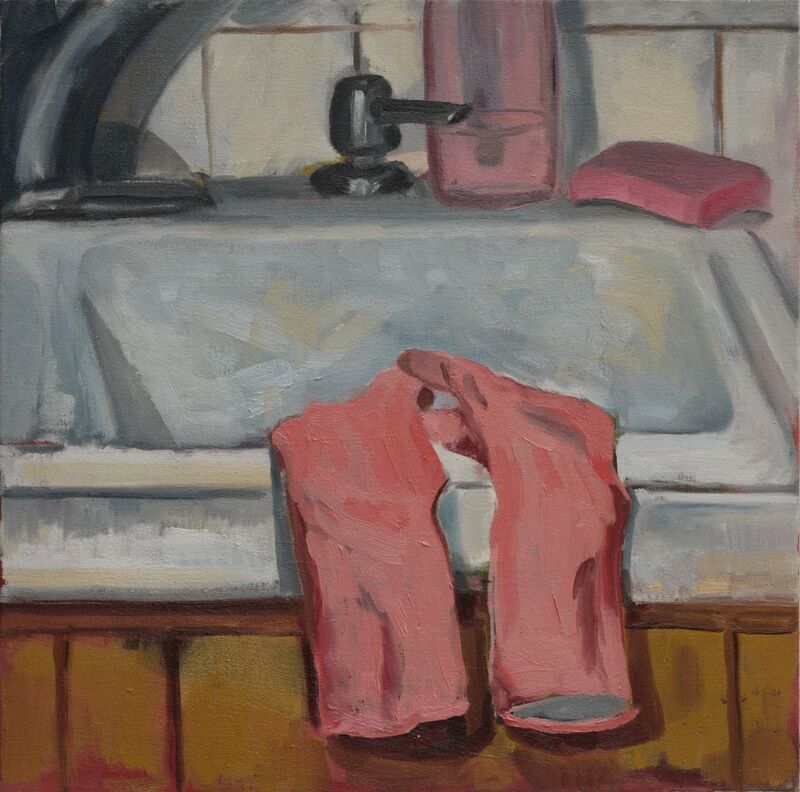 Pink dish gloves on a white kitchen sink with pink sponge and dish soap. 