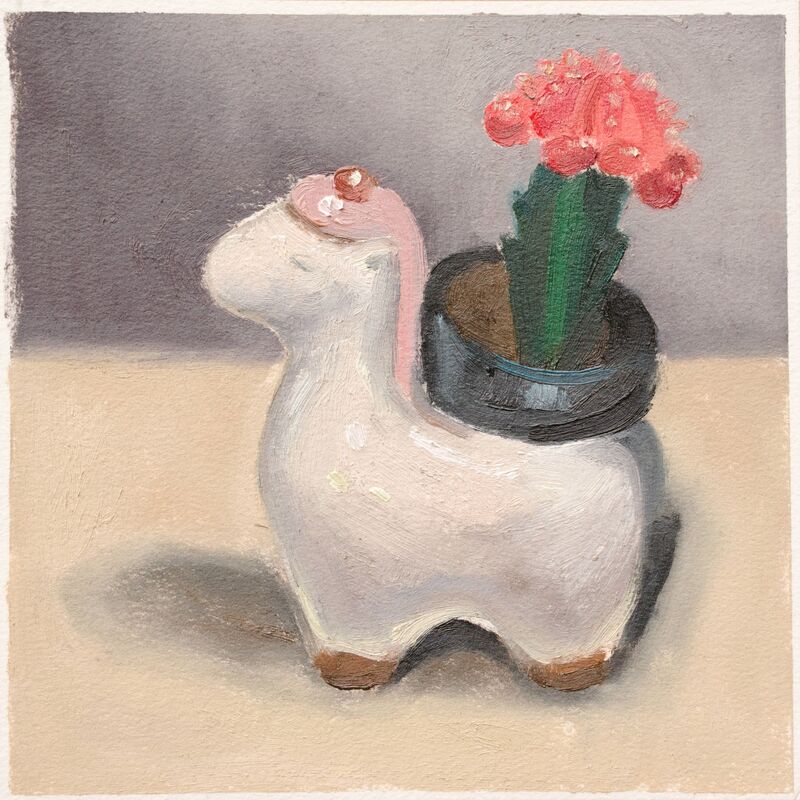Llama plant holder (white) with small cactus blooming pink, still life
