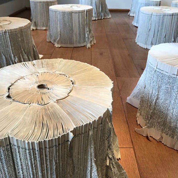 Stumps made of pages of text on a wooden floor