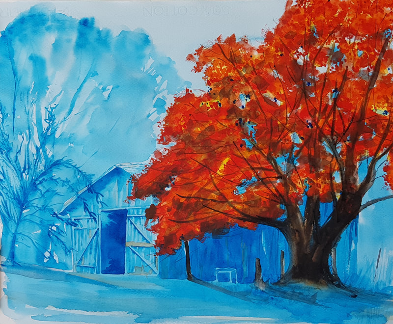 Blue barn, with tree in bright autumn color to one side.
