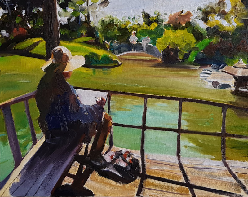 Woman with a hat gazing out at a garden, drawing on a sketch pad