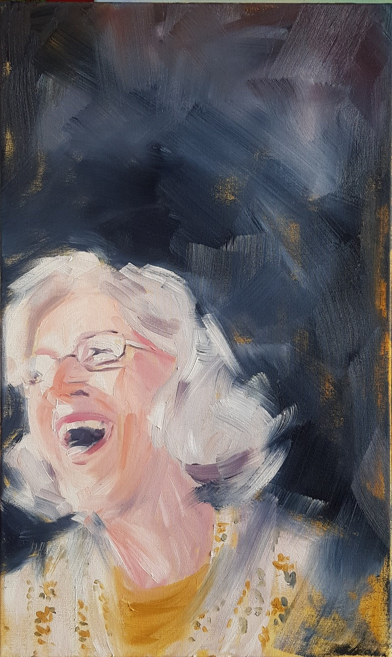 laughing woman with silver hair, wearing glasses, in three-quarters profile
