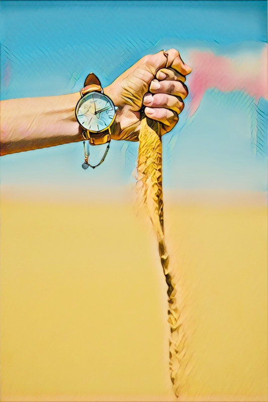 Arm with large watch. Sand is spilling from the  hand. Blue sky background. 