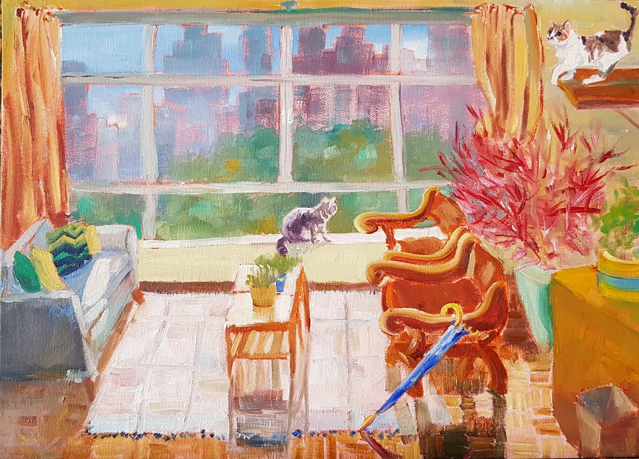 Table in front of window with city view, cat on window-sill