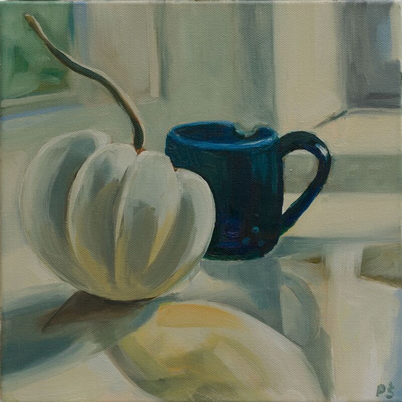 White pumpkin with blue coffee cup. 