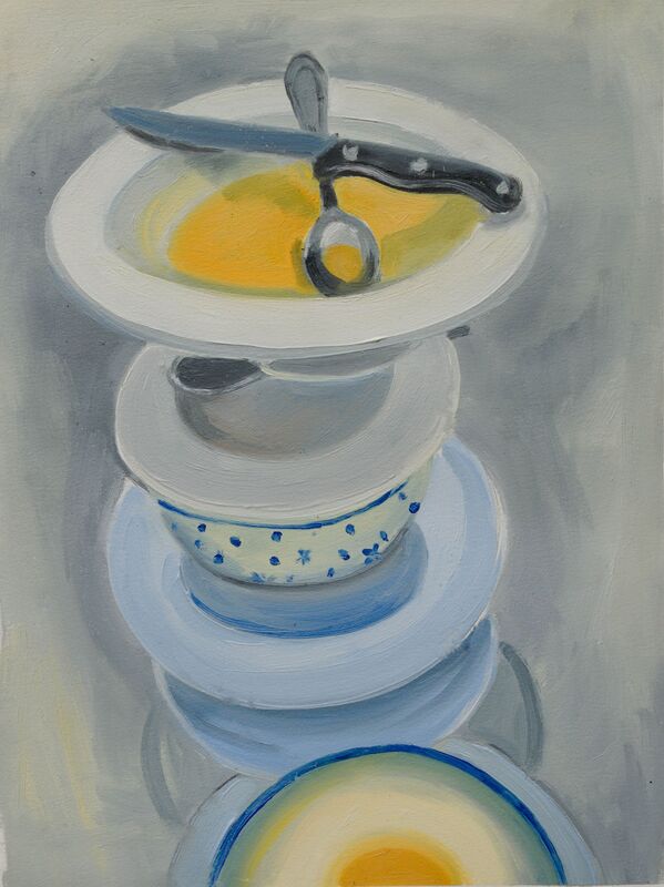 Still life, stack of tea cups and saucers, white bowl on top with yellow liquid in the bottom. Knife and spoon rest across the top of the bowl.