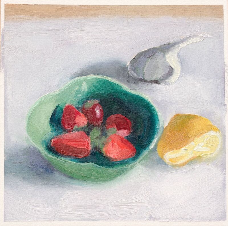 Still life, strawberries in a green bowl beside a squeezed half lemon and garlic bulb