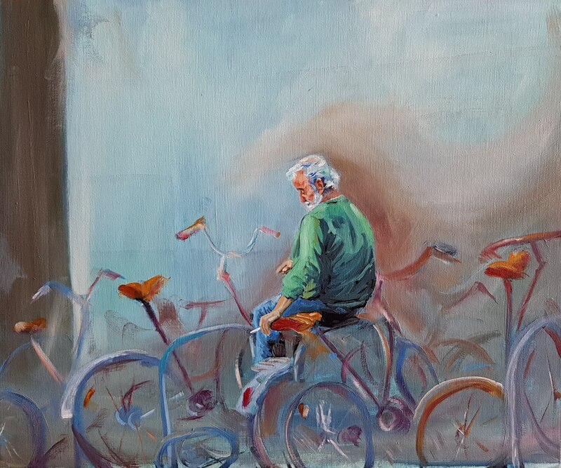 Man with white hair, wearing green shirt, perched among several bicycles